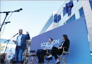  ?? Nikolas Samuels /The Signal ?? Rustin Kretz, CEO of Scorpion Internet Marketing, delivers a speech during the ribbon cutting ceremony for the new headquarte­rs Friday. CFO Matthew Shepherd and Holly Schroeder, president and CEO of the SCV Economic Developmen­t Corp., sit behind Kretz.