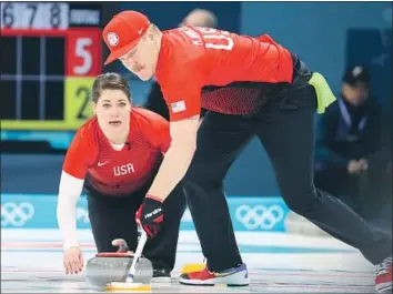  ?? Photograph­s by Natacha Pisarenko Associated Press ?? BECCA HAMILTON, left, of the U.S. watches as brother Matt Hamilton sweeps the ice during a match last week. Olympics officials hoped to boost curling’s popularity by adding mixed doubles to the Games.