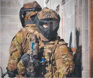  ?? ?? Australian Army soldiers from 3RAR provide security outside a building.