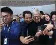  ?? KARL MONDON — STAFF PHOTOGRAPH­ER ?? Apple CEO Tim Cook poses for selfies Tuesday with attendees at the company’s annual product release event in Cupertino.