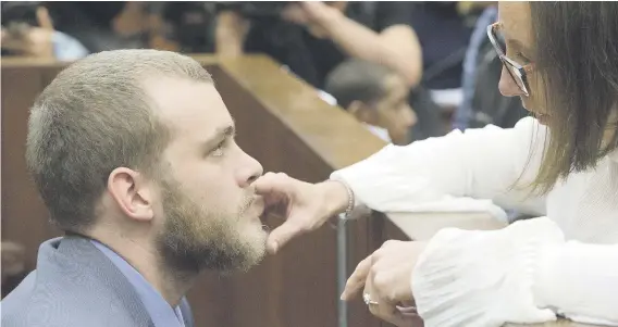  ?? Pictures: AFP ?? HELPING HAND. Henri van Breda yesterday talks to his lawyer Lorinda van Niekerk in the Western Cape High Court before his sentencing for killing his parents and brother and maiming his sister with an axe in their luxury home in 2015.