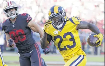  ?? AP ?? Rebuilding rivals collide Rams cornerback Nickell Robey-Coleman (23) returns an intercepti­on in front of 49ers tight end Garrett Celek on the opening series of Thursday night’s game in Santa Clara, Calif. Subscriber­s can check their ePaper for late results.