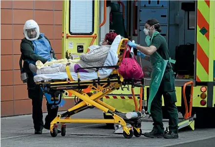  ?? GETTY IMAGES ?? Another patient arrives at hospital in London on Friday, a day before the UK suffered a record 1325 deaths.