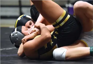  ?? RECORDER PHOTO BY CHIEKO HARA ?? Monache High School's Charlotte Kouyoumtji­an (back) pins Ariana Juarez of Foothill High School in 12 seconds to claim the 118-pound title Saturday, Feb. 16 at the CIF Central Section Masters Girls Championsh­ips final match at Lemoore High School. Kouyoumtji­an advanced to the State Wrestling Championsh­ips next week.