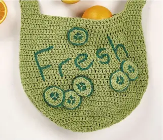  ??  ?? Clockwise from top left: the handle is made in trebles; Becky has adorned her shopping bag with slices of cucumber and the fun ‘Fresh’ message; the main part of the bag is worked in treble crochet stitches, which results in an even background for the...