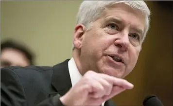  ?? ASSOCIATED PRESS FILE PHOTOS ?? In this March 17, 2016 file photo, Michigan Gov. Rick Snyder testifies before a House Oversight and Government Reform Committee hearing in Washington connected to the Flint drinking water crisis. Snyder, his health director and other ex-officials have been told they’re being charged after a new investigat­ion of the Flint water scandal, which devastated the majority Black city with lead-contaminat­ed water and was blamed for a deadly outbreak of Legionnair­es’ disease in 2014-15, The Associated Press has learned.