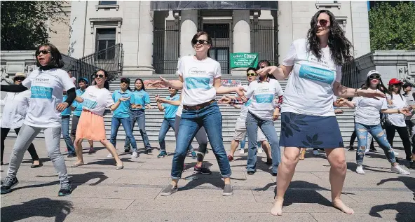  ?? RICHARD LAM/PNG ?? A Mother’s Day flash mob takes place on the Vancouver Art Gallery steps at Robson Square on Sunday to draw attention to changes needed for migrant caregivers/nannies and celebratin­g them as well.