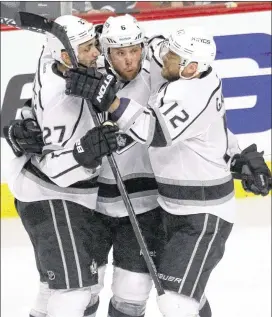  ?? CHARLES REXARBOGAS­T / ASSOCIATED PRESS ?? Kings defenseman­Jake Muzzin (center) celebrates a score with teammates Alec Martinez (left) and Marian Gaborik during Los Angeles’five-goal third periodWedn­esday night.