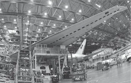  ?? TED S. WARREN/AP FILES ?? A Boeing 777 plane is seen on the assembly line in Everett, Wash. The Trudeau government has threatened to abandon the Super Hornet purchase from Boeing, as the U.S. aerospace giant has accused Montreal-based Bombardier of selling its CSeries jets at...