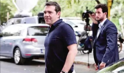  ?? — AFP ?? ATHENS: This file photo taken on August 21, 2015 shows Greek Prime Minister Alexis Tsipras arriving for a meeting at his party’s Headquarte­rs.
