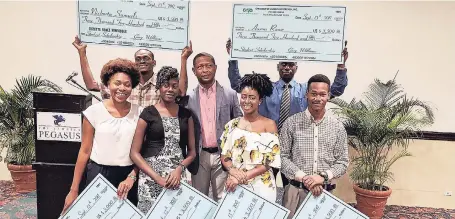  ??  ?? Gary Williams (centre), founder and chairman of Children of Jamaica Outreach (COJO), poses with 2017 scholarshi­p awardees (back, left to right) Nickorta Samuels and Aaron Rowe and (front, left to right) Golda-Mae Bullock, Shantanna Dixon, Chantell Campbell and Kareem Carr. JetBlue is a sponsor of COJO’s initiative­s.