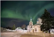  ?? ASSOCIATED PRESS FILE PHOTO ?? In this March 17, 2013, file photo, the aurora borealis, or northern lights, fill the night sky above the Holy Assumption of the Virgin Mary Russian Orthodox church in Kenai, Alaska. The phenomenon occurs when electrical­ly charged particles from the sun enter the earth’s atmosphere.