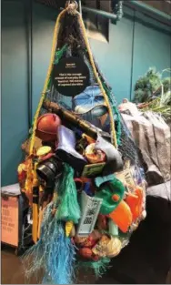  ?? TOM TATUM — FOR DIGITAL FIRST MEDIA ?? Vancouver Aquarium display focusing on plastic pollution points out that this net full of discarded plastic represents the daily average of such debris found on 100 meters of exposed shoreline.