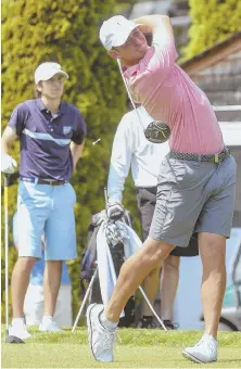  ?? STAFF PHOTOS BY NICOLAUS CZARNECKI ?? IN THE SWING: Matthew Organisak (left) looks on as Matt Parziale drives off the 12th tee at Woodland Golf Club during the final round of the Ouimet Memorial Tournament yesterday in Newton.