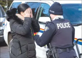  ?? The Canadian Press ?? An asylum seeker claiming to be from Turkey is arrested after crossing the border into Canada from the United States on Thursday near Hemmingfor­d, Que.