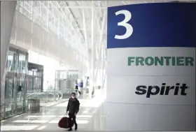  ?? LUKE SHARRETT — BLOOMBERG ?? Frontier Airlines and Spirit Airlines signage is seen at Indianapol­is Internatio­nal Airport on Feb. 7.