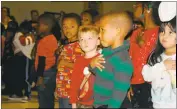  ??  ?? Eva Turner Elementary School students hold their hands over their hearts for a performanc­e of “The Star Spangled Banner” during the school’s Veterans Day program Friday.