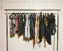  ?? ?? Carlson says she likes to use a rolling rack to hang each category of clothing as she goes through the closet.