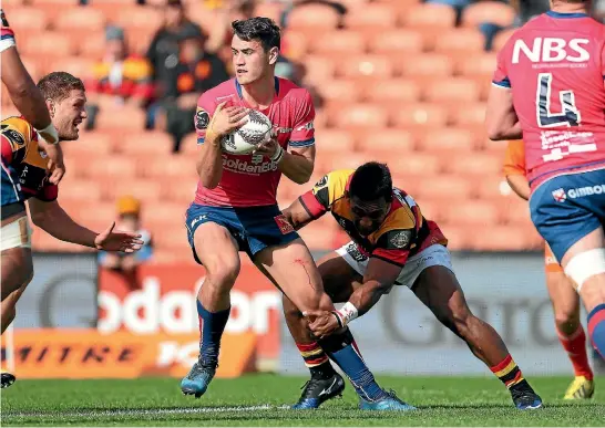  ?? PHOTO: PHOTOSPORT ?? Tasman fullback Will Jordan assesses his options as he is held up in a tackle during the nailbiting 31-29 win over Waikato yesterday.