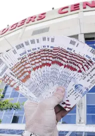  ?? POSTMEDIA NEWS FILES ?? Scalpers outside Rogers Centre in Toronto are trying to sell tickets they purchased earlier for profit, the whole point of the enterprise, but sometimes fans can also find deals they may not get from the box office.