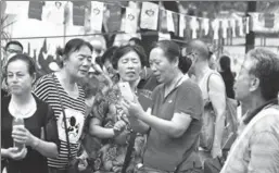  ?? ZHANG YONG / CHINA NEWS SERVICE ?? Parents exchange informatio­n about their children at a matchmakin­g market in Jinan, Shandong province.