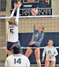  ?? Michelle Petteys, Heritage Snapshots ?? Abbey Blevins hits a shot past a Marist defender during the Class AAAA state semifinals on Saturday. However, Heritage’s best-ever playoff run would end with a three-set loss to the eight-time state champions.