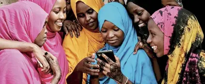  ?? ?? This file photo shows young Somali women looking at a smartphone at Dadaab refugee complex in northeast Kenya.