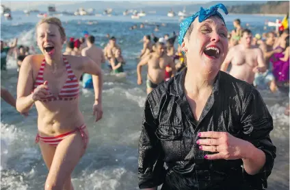  ?? GERRY KAHRMANN/PNG ?? Thousands braved the cool temperatur­es of English Bay on Thursday for the 95th annual Vancouver Polar Bear Swim.