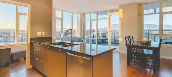  ??  ?? This Vancouver condo offers captivatin­g views from its corner unit position with wraparound windows that frame views of the ocean, mountain, city and English Bay summer fireworks.