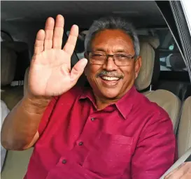  ?? (AFP) ?? Sri Lanka’s president-elect Gotabaya Rajapaksa waves at supporters as he leaves the election commission office after being declared winner in the presidenti­al election, in Colombo on Sunday