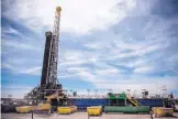  ?? ROBERTO E. ROSALES/JOURNAL ?? The U.S. Bureau of Land Management’s Carlsbad Field Office managed an auction this week that yielded a record $972.8 million. Above is an oil well drilling operation in Jal in March.