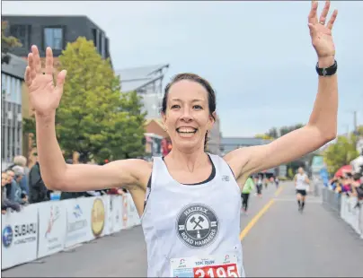  ?? KATIE SMITH/THE GUARDIAN ?? Erin Poirier, a runner from Charlottet­own who now lives in Halifax, won the women’s 10-km race at the 14th Annual P.E.I. Marathon, which ended in downtown Charlottet­own on Sunday.