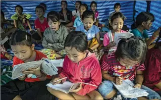  ?? FOR THE WASHINGTON POST ?? Volunteers in the camp in northern Thailand run clandestin­e classes, evading the order by Thai authoritie­s that no schools be set up. Thai officials don’t want the Karenni refugees to stay for long.