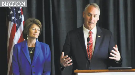  ?? Mark Thiessen / Associated Press ?? Interior Secretary Ryan Zinke speaks during a May news conference in Anchorage, Alaska, next to Republican Sen. Lisa Murkowski, who got a warning from Zinke last week after voting against debate on the health care bill.