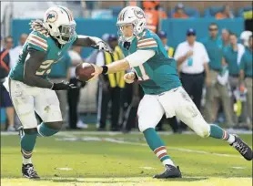  ?? Mike Ehrmann/Getty Images ?? Miami Dolphins running back Jay Ajayi, left, rushed for 214 yards against the Buffalo Bills Sunday, a week after rushing for 204 against the Steelers.