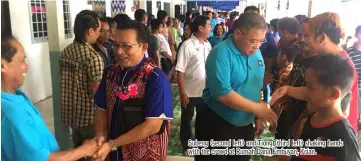  ??  ?? Subeng (second left) and Tiong (third left) shaking hands with the crowd at Rumah Dana Embuyan, Krian.