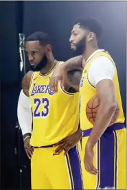  ?? RINGO H.W. CHIU — THE ASSOCIATED PRESS ?? Los Angeles Lakers forwards LeBron James, leftt, and Anthony Davis, right, pose for photos during the NBA basketball team’s media day in El Segundo Friday.