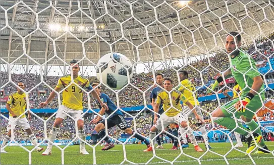  ??  ?? Japan’s Yuya Osako, third left, scores past Colombia goalie David Ospina, right, in World Cup group game with ball supplied by Adidas