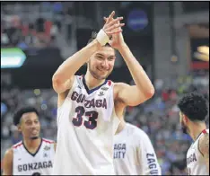  ?? RONALD MARTINEZ / GETTY IMAGES ?? Killian Tillie, a 6-foot-10 freshman from Cagnessur-Mer, France, leads the applause as the Bulldogs celebrate their defeat of South Carolina on Saturday.