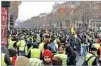  ??  ?? BENOIT TESSIER/REUTERS Protesters wearing yellow vests gather as they take part in a demonstrat­ion by the “yellow vests” movement in Paris, France, December 15, 2018.