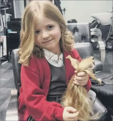  ?? ?? ‘CHUFFED’ Fiveyear-old Gracie-Mae donates her hair to the Little Princess Trust, receiving a certificat­e for her fundraisin­g efforts, left, which will pay for the wigs of two sick children