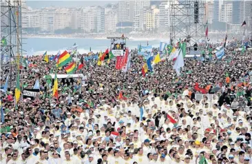  ??  ?? Crowds wait for the arrival of Pope Francis to celebrate Mass on the Copacabana beachfront in Rio de Janeiro, Brazil, on Sunday. The Pope wrapped up an historic trip to his home continent by urging young people to go out and spread their faith ‘to the...