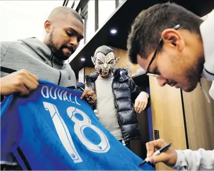  ?? ALLEN McINNIS ?? Impact right back Chris Duvall gets his jersey signed by Shamit Shome as James Pantemis sports a Halloween costume as the players cleared out their lockers Wednesday. The Impact finished seventh in the Eastern Conference with a 14-16-4 record, missing the playoffs by four points.