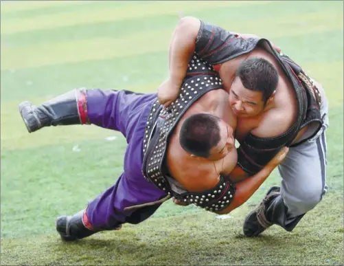  ?? PHOTOS BY CUI MENG / CHINA DAILY ?? Wrestling is one of the ‘three manly skills’ of the Mongolian ethnic group. The sport, along with horsebacki­ng riding and archery, forms the basis of the competitio­n at the annual Nadaam festivals.