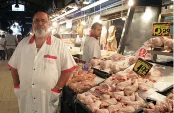  ?? SPYROS TSAKIRIS/THE ASSOCIATED PRESS ?? Butcher Kleanthis Tsironis, at Varvakios Market in Athens, says he doesn’t know how much longer he can keep all of his employees now that the banks are closed, credit cards are blocked and ATM withdrawal­s have been limited.