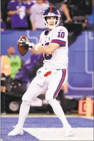  ?? Julio Cortez / Associated Press ?? New York Giants quarterbac­k Eli Manning looks to pass against the Philadelph­ia Eagles Thursday night in East Rutherford, N.J. On Friday, coach Pat Shurmur reiterated that Manning will remain the starting QB.