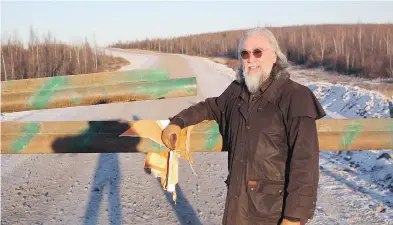  ?? JESSE SNYDER / NATIONAL POST ?? Floyd Roland, a former premier of the Northwest Territorie­s, stands at the beginning of the year-round road from Inuvik to Tuktoyaktu­k. Constructi­on of the road is scheduled for completion this winter.