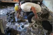  ?? JASON H. DEAREN — ASSOCIATED PRESS ?? Walter Coker surveys the damage in his furniture storage shed in Crescent Beach, Fla. Coker runs Genung’s Fish Camp and Marina on the shore of the Matanzas River, and saw storm surge from Hurricane Matthew run “like a river” through his property,...