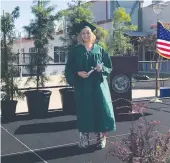  ?? Courtesy photo ?? Hannah Graham walks across the stage at the River Valley High School drive-through graduation ceremony on Thursday.