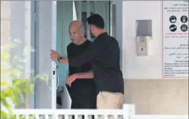  ?? Ariel Schalit ?? The Associated Press Former Israeli Prime Minister Ehud Olmert, left, leaves prison Sunday in Ramle, Israel, after he was paroled for good behavior.